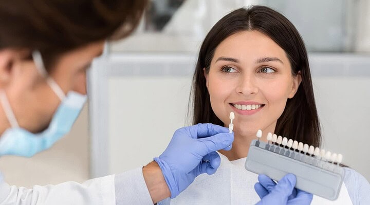 woman smiling after receiving dental restoration