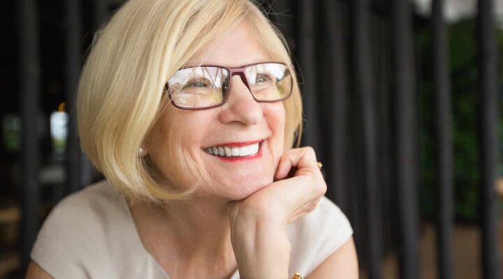 older woman smiling with all on 4 dental implants