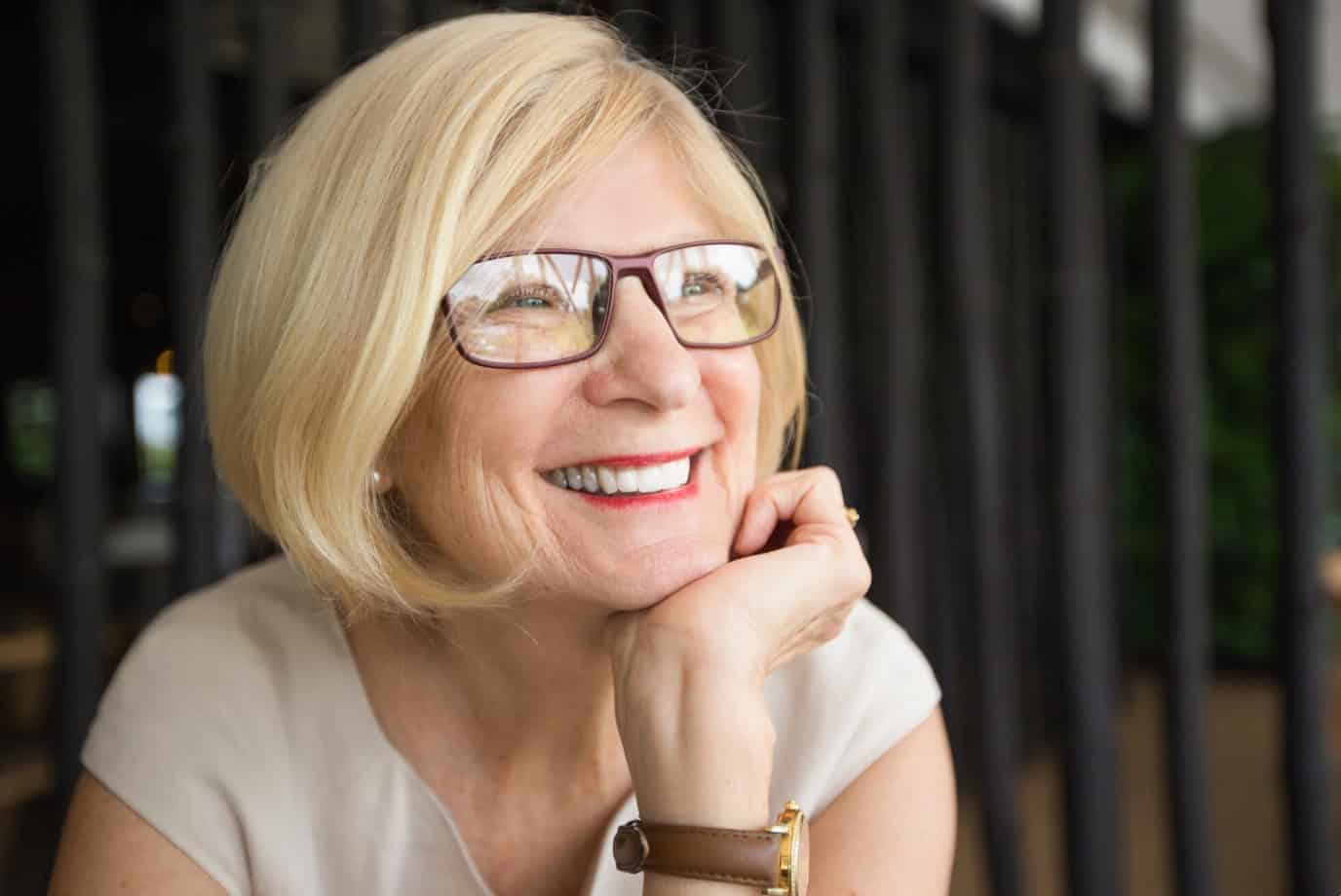 older woman smiling with all on 4 dental implants