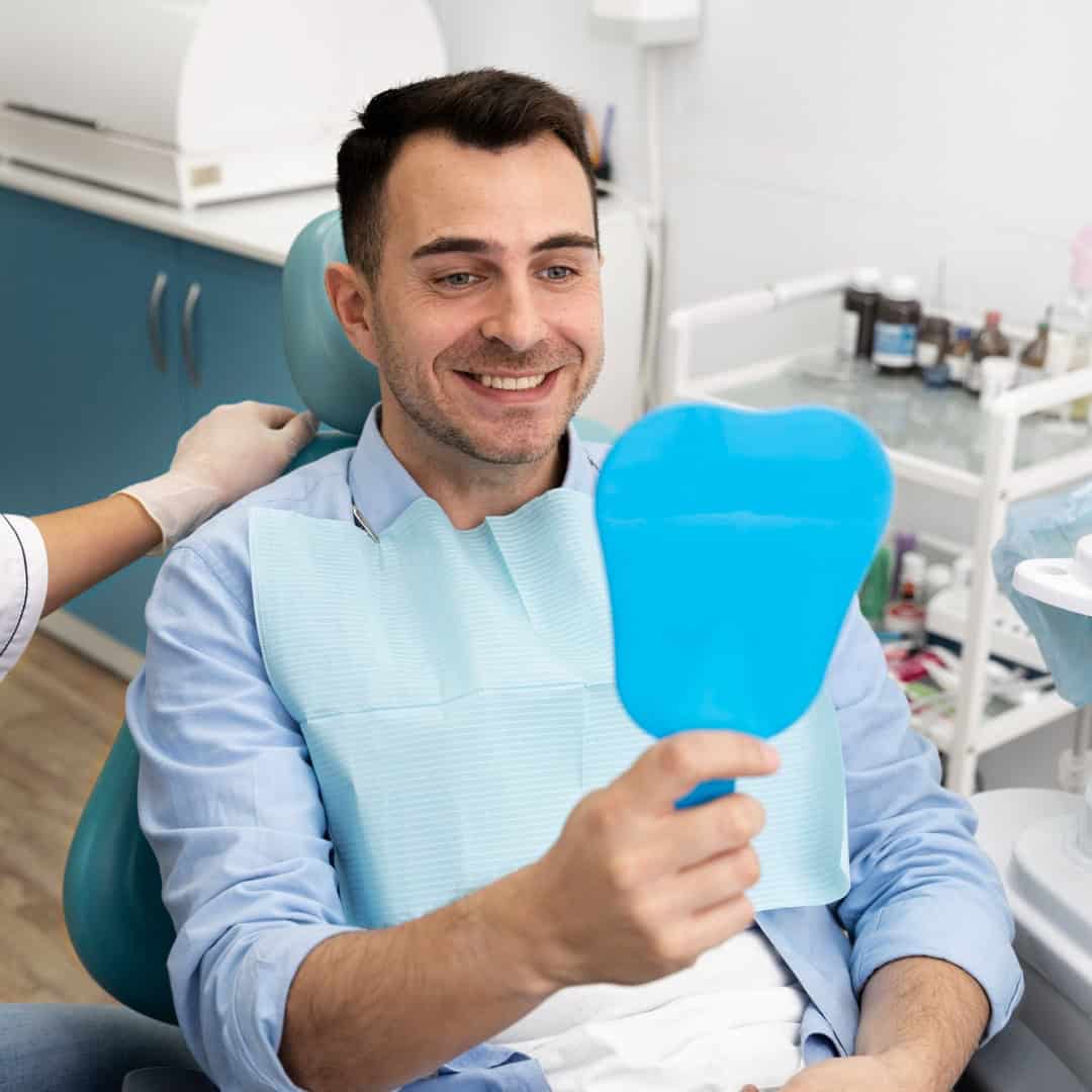 man admiring new smile with mirror