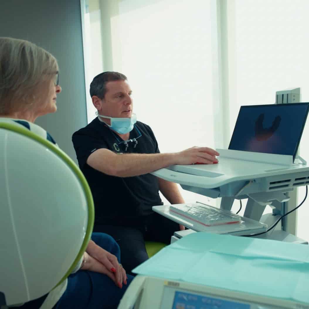 dr steven rostkier consulting with a patient