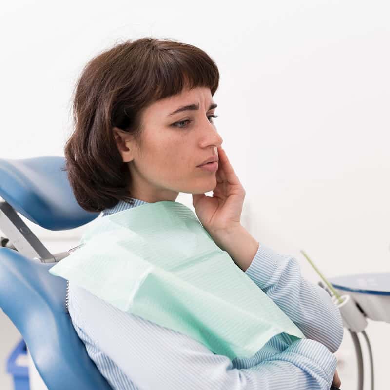 female patient experiencing tooth pain dentist practice