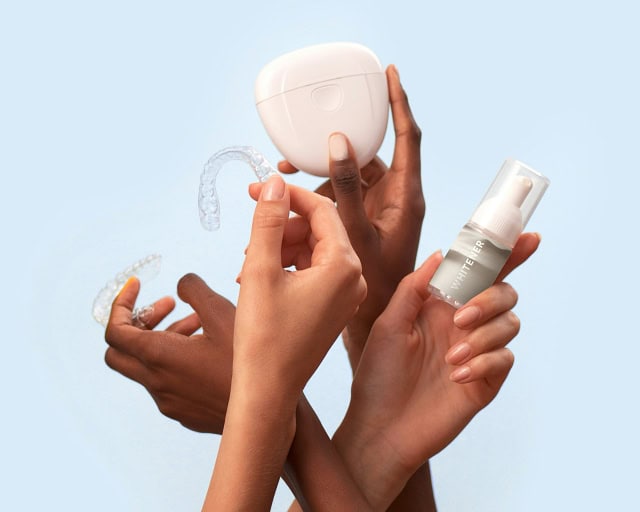 Female hands holding up teeth whitening products